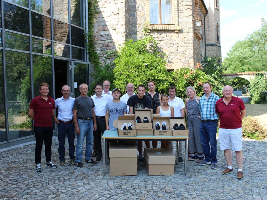 Die Jugendlichen (Bildmitte) freuten sich über die neuen Sportschuhe.